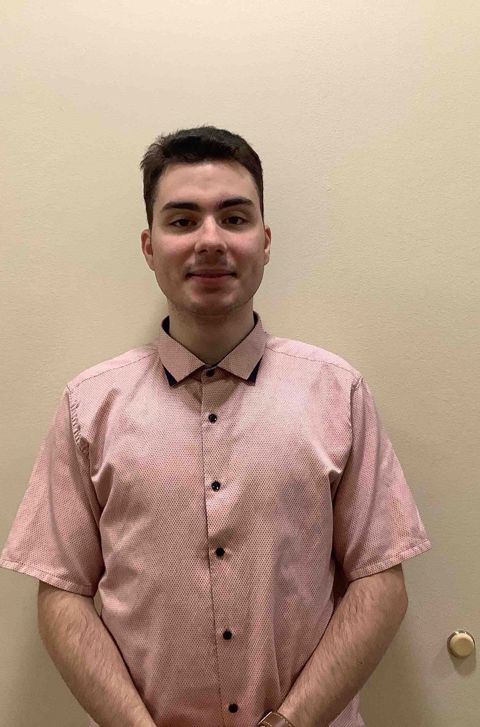 a man wearing a pink shirt