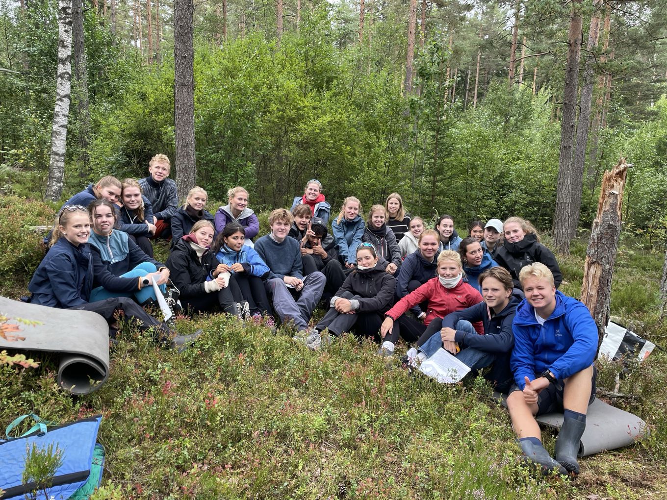 Foto: Foss vgs En gruppe mennesker som sitter i skogen